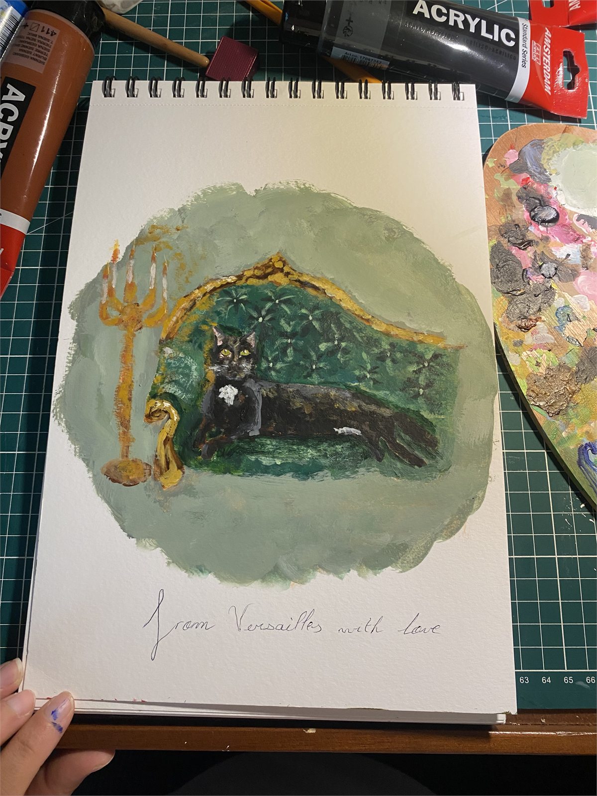 Black cat portrait painted by Sarah in her sketchbook